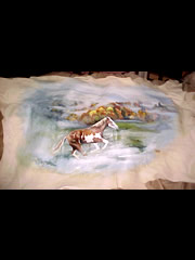 Deer hide painting of a paint horse