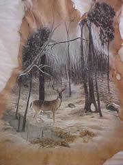 Deer hide painting of a buck in a wintery forest