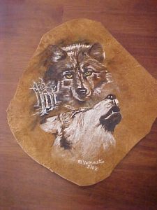 Wolf heads on deer hide scrap