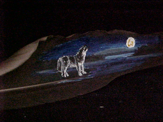 Wolf howling at moon on feather